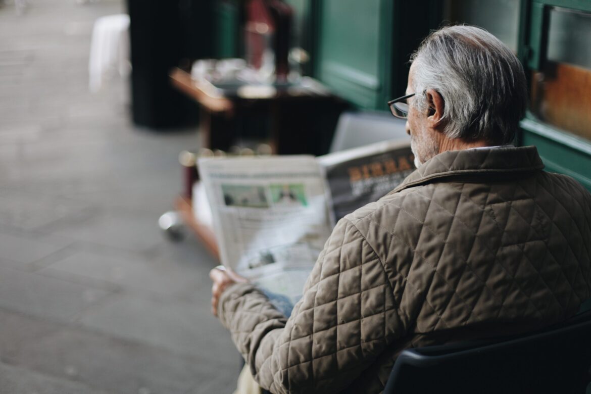 side job, an old man reading the newspaper